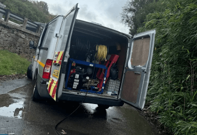 Our Drain unblocking van with high-pressure jetting equipment and hose reels, attending a blocked drain on a residential road in Falmouth