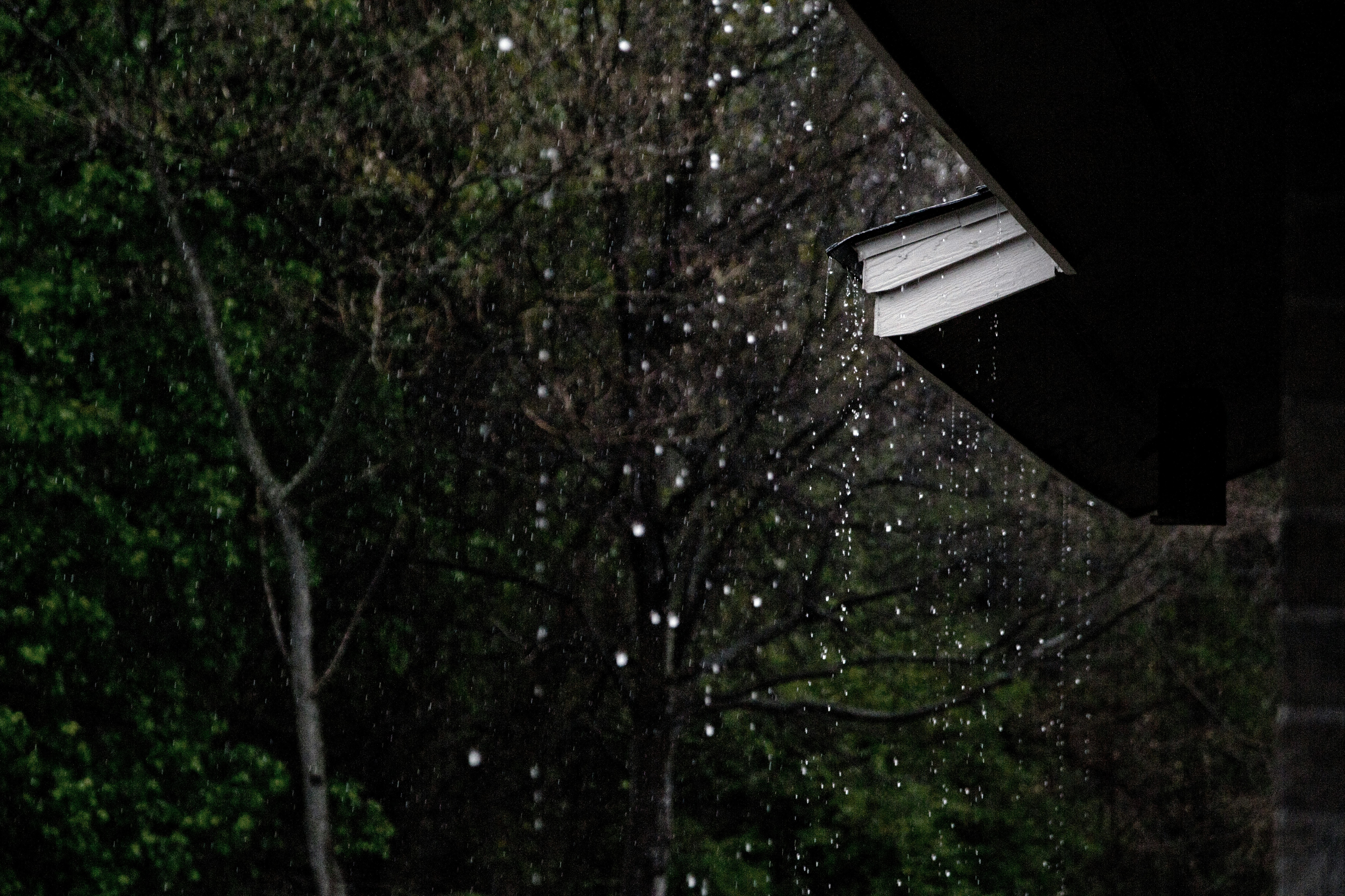 Rainwater falling off house roof
